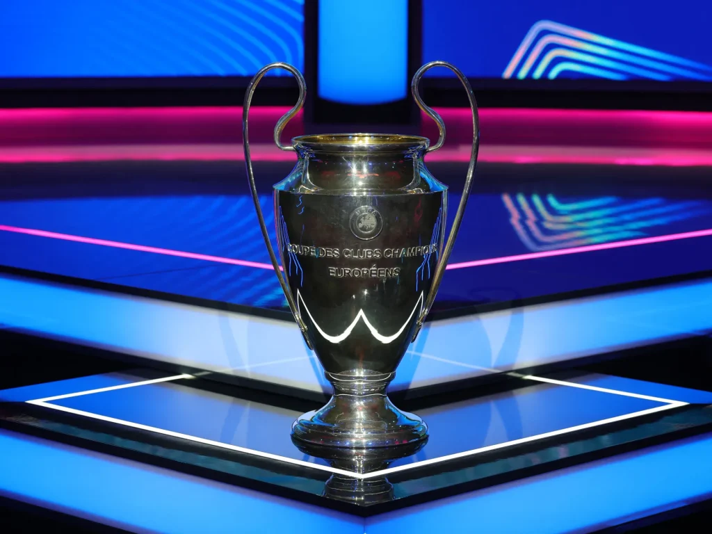 “UEFA Champions League trophy on a neon-lit stage during the 2025–26 season presentation.”