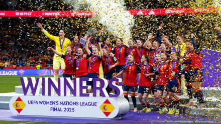 Spain women’s national football team lifting the UEFA Women’s Nations League 2025 trophy with confetti falling during their victory celebration.